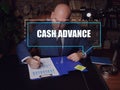 CASH ADVANCE inscription on the screen. male inspecting market data. AÃÂ cash advanceÃÂ is a short-term loan from a bank or an